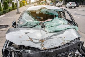 Road collision results in damaged vehicles after a car crash in the city.