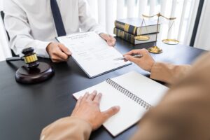 A lawyer or judge presents contract documents to a client, symbolizing law and legal services.