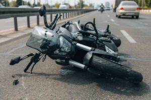 The motorcycle lies on the sidewalk after a ride.